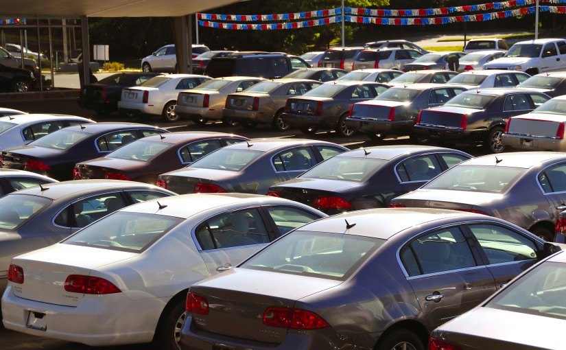bigstock-A-row-of-new-cars-parked-at-a--18355958
